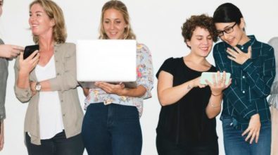 A group of women looking at their electronic devices