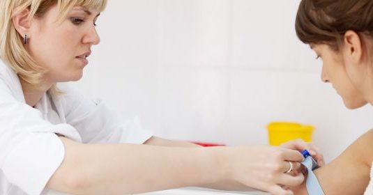 A woman receiving a test from a doctor