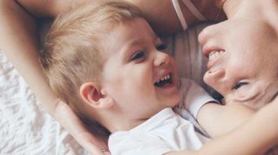 A mother and young son laying together