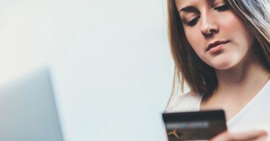 A woman looking at her electronic devices