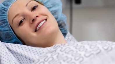 A woman in a hospital gown preparing for a procedure