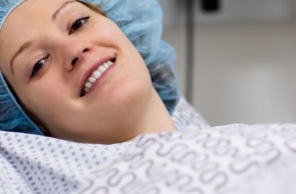 A woman in a hospital gown preparing for a procedure