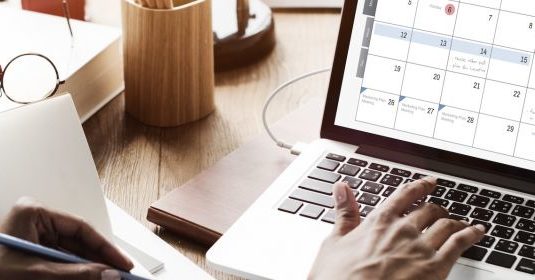 A woman marking a day on a calendar