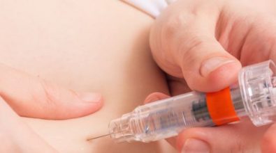A woman injecting fertility drugs in her stomach