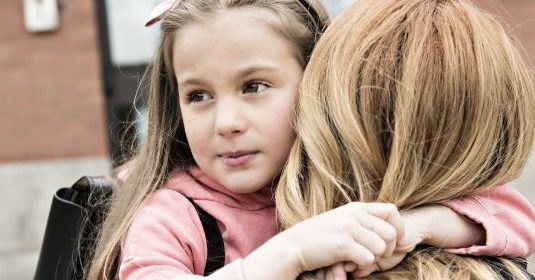 A child being held by her mother