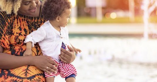 A woman playing with her son